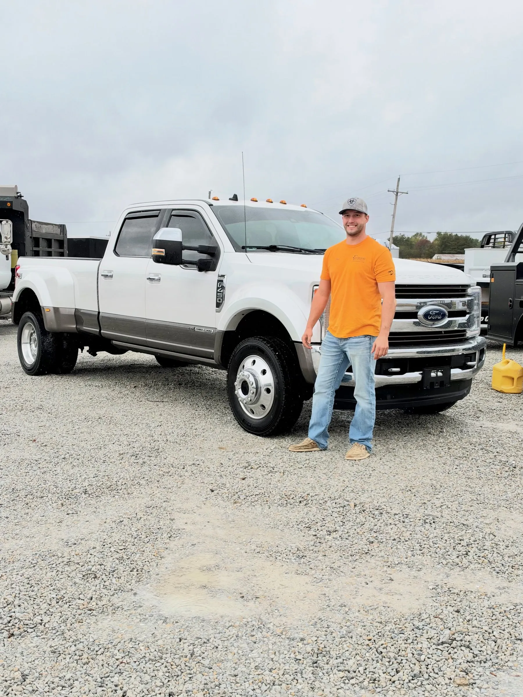 Dilan Pagrabs standing next to the DHI Ford F-450 dually