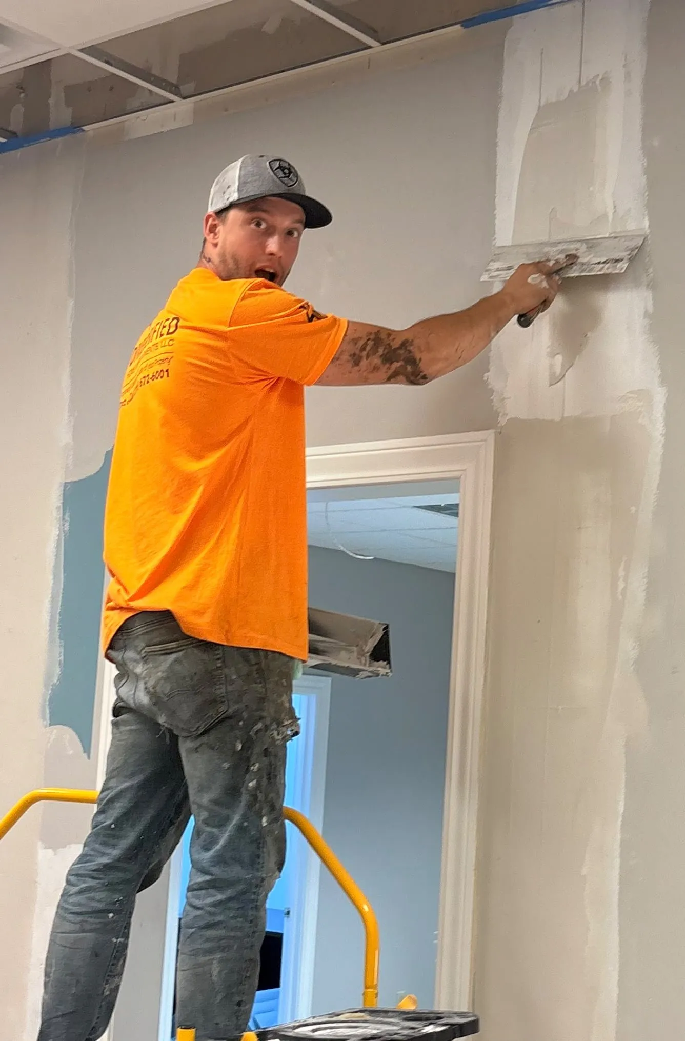 Dilan Pagrabs finishing drywall on a job site